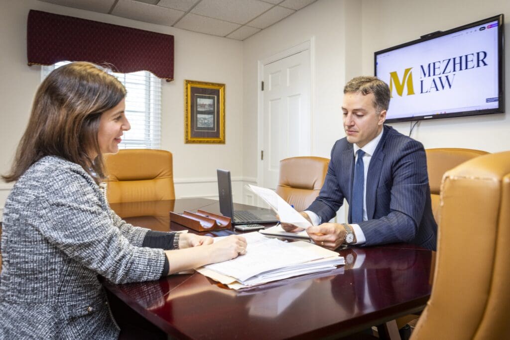 Joseph Mezher and Christine Caldemeyer reviewing legal documents